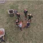 Tree Planting Arbor Day aerial view of people with shovels around a tree