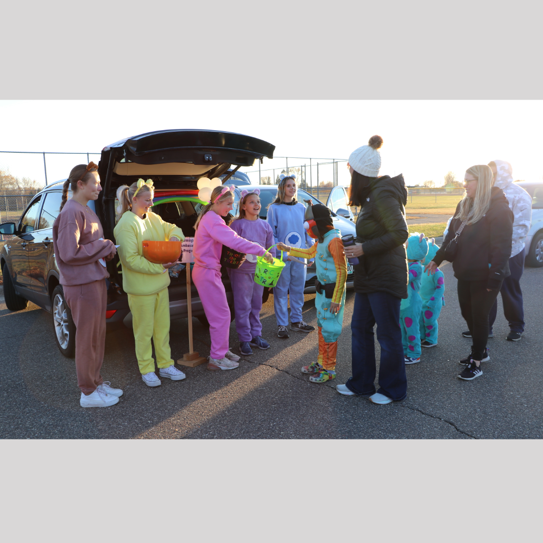 Halloween Walk event with Farmington Ambassadors dressed as Care Bears handing out candy